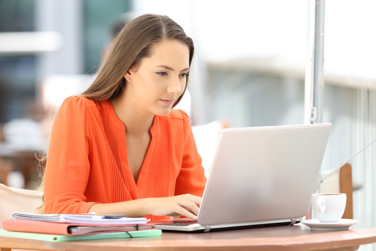 woman doing online learning on her laptop