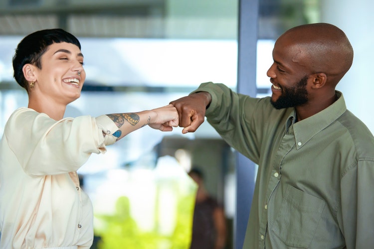Coworkers celebrating with a fist bump