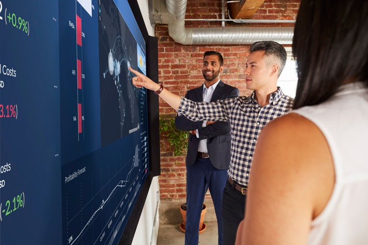 people gather together to work over a digital blackboard
