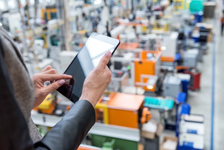 Manager working on tablet in factory