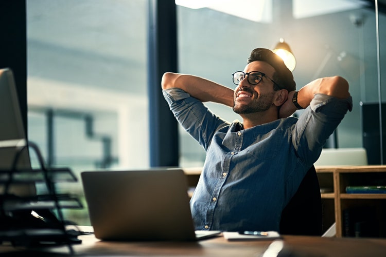 Shot of a young businessman taking a break at his desk