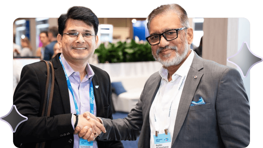 Three men smiling, standing close together at a conference. Each wears a conference badge and carries a backpack. The background shows a busy, blurred crowd.