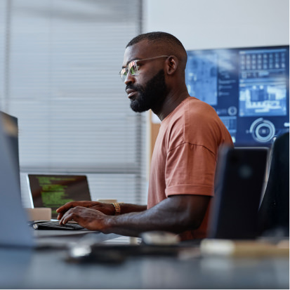 Man is coding at desk - stock photo