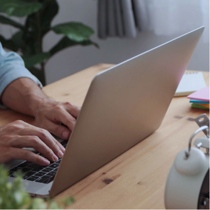 Casual businessman typing and using laptop - stock photo