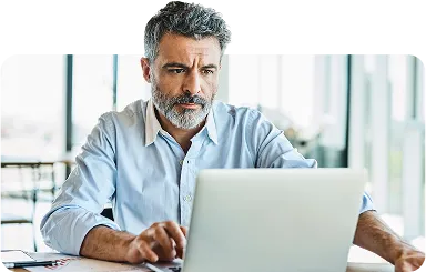 Businessman using laptop in coworking office - stock photo