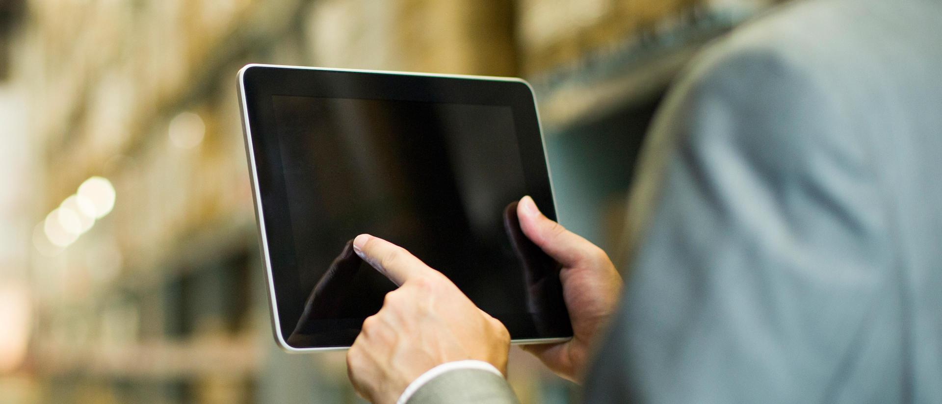 Businessperson using a tablet in a warehouse