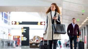 a woman walking through an airport