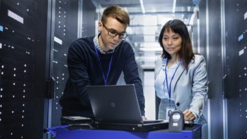 man and woman looking at laptop