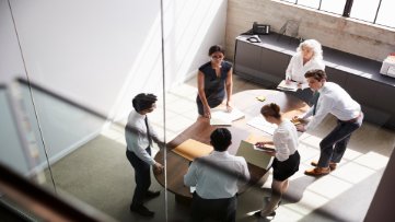 Employees in a meeting discussing seniority