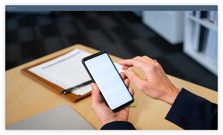 A person's hands holding a phone and engaging with the screen.