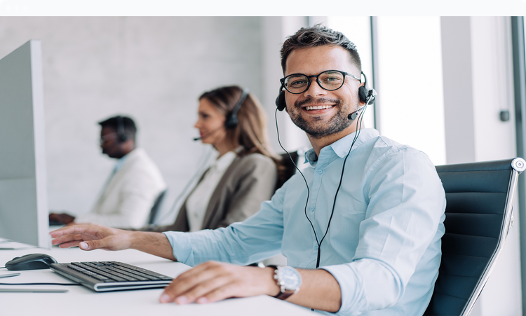 man at a computer wearing a phone headset who gives support immediately after the introduction of a new system or process.