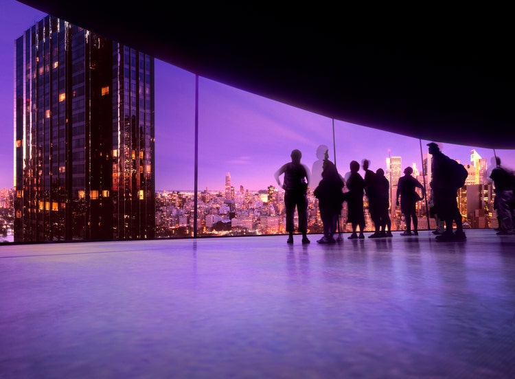 coworkers looking at a skyline from a window