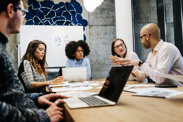 Five business people in a business meeting.