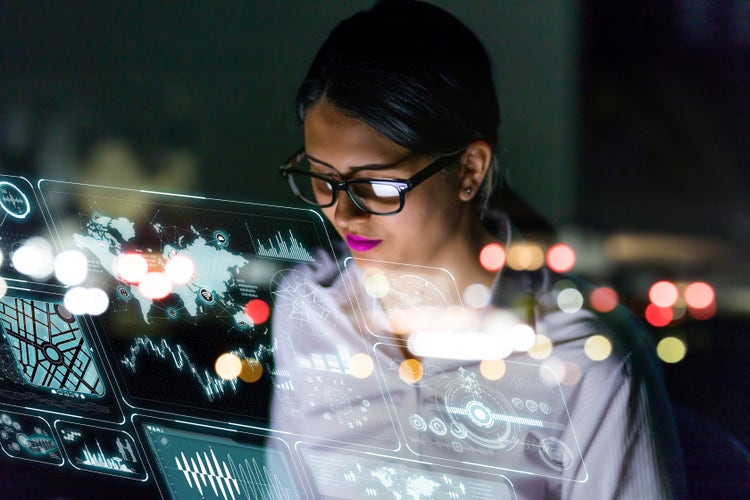 Engineer looking at various information in screen of futuristic interface