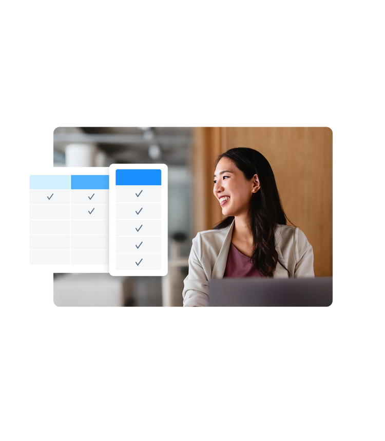 woman looking away from computer and smiling
